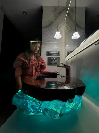 A shot of me in the bathroom where the custom resin basin was installed. The piece completely transforms the look and feel of the space.