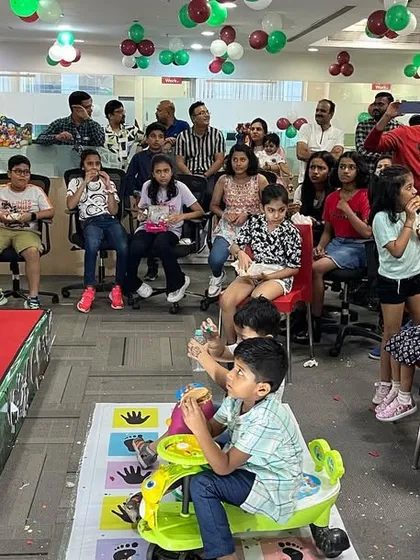 After the main show, it's time for treats. The kids at this corporate event are enjoying some snacks while still buzzing with excitement from all the magic they just witnessed.