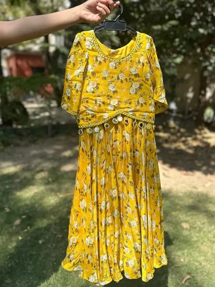 The yellow floral dress with a mirror-work belt. A perfect summer party dress.