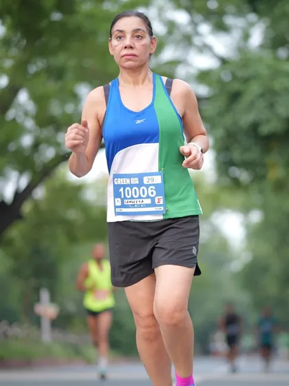 A focused runner during the Green Milers event. I ensure my race routes are well-planned and scenic, providing a great experience for every participant.