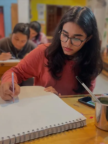 A student deep in concentration during a watercolor session. Our classes are designed to help you focus and build skills step by step.