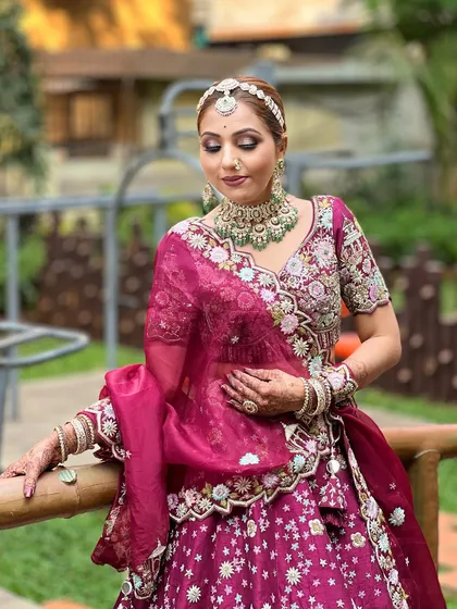 A unique and glamorous look inspired by Aditi Rao Hydari. The model wears a deep magenta lehenga with a stunning Polki and emerald choker.