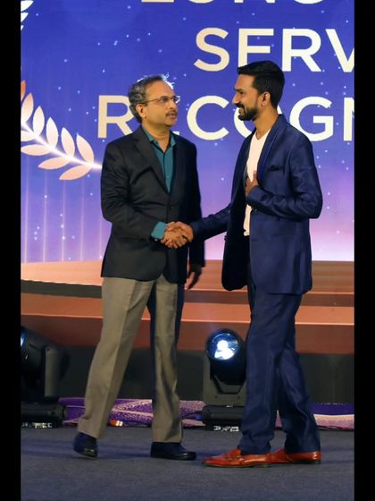 A handshake of appreciation on stage at the Emerson event. It's a pleasure to connect with clients who value art and storytelling.