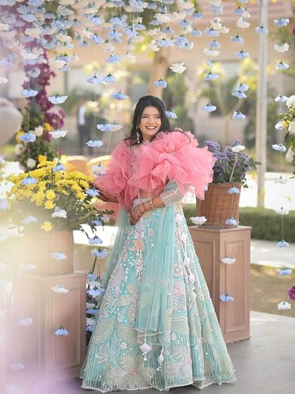 A client looking like a doll with her soft, open hairstyle and dramatic pink ruffled top.