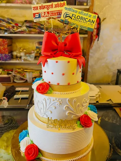 This three-tiered corporate celebration cake features the logos of multiple companies, making it ideal for partnership announcements or large-scale company events. The elegant design with a bold red bow makes a strong statement.