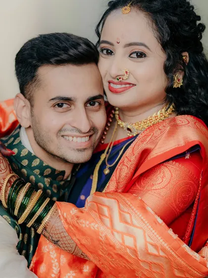 A warm, happy hug between the newly engaged couple. This photo is overflowing with joy and affection, a perfect memory from their special day.