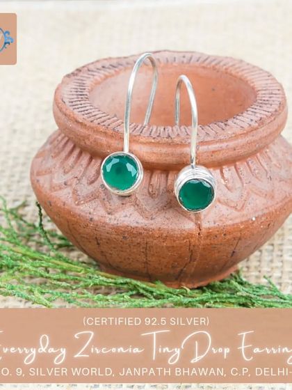 A variation of our tiny drop earrings, this pair features a vibrant green zirconia stone for a subtle pop of color.