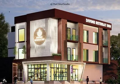 This evening render of the Divine Retreat Inn demonstrates the impact of architectural lighting. The illuminated signage and strategically placed lights accentuate the textured facade, giving the building a sophisticated and dynamic presence after dark.