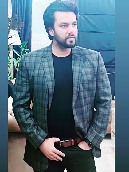 Dressed in a blazer, ready for a professional engagement. My work extends to consultations and meetings outside the courtroom.
