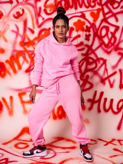 A full-length shot of the graffiti set, showcasing the model's outfit and the vibrant, chaotic energy of the custom backdrop. This is perfect for clients who want to make a bold statement.