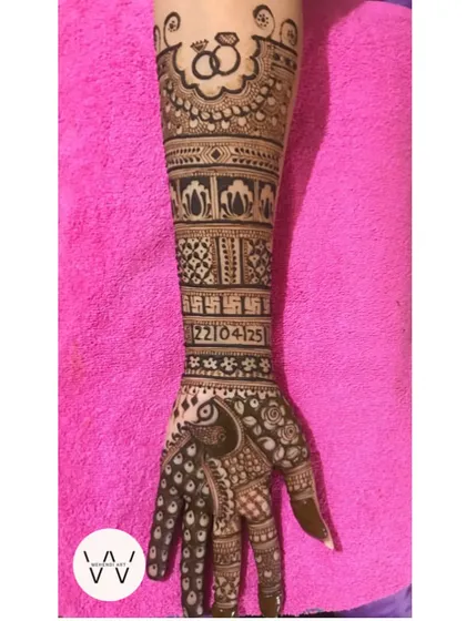 A single arm view of an intricate engagement design, highlighting the beautiful peacock and the engagement ring motif at the top.