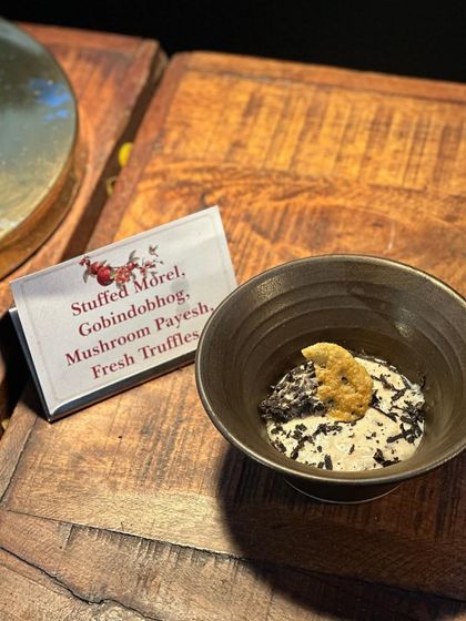 A close-up of our Stuffed Morel with Gobindobhog Mushroom Payesh and Fresh Truffles. This appetizer combines the rare, earthy flavour of morel mushrooms with fragrant rice pudding and luxurious truffle.
