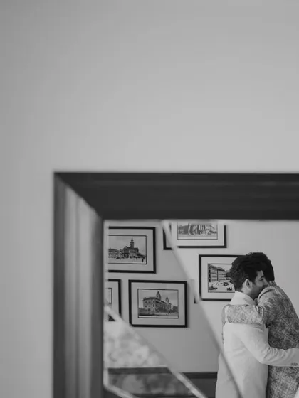 A tender hug between family members, captured in a mirror's reflection. A moment of love and support before the big step.