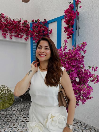 A happy, smiling shot in this beautiful white dress. The background of bougainvillea flowers makes the neutral outfit pop.