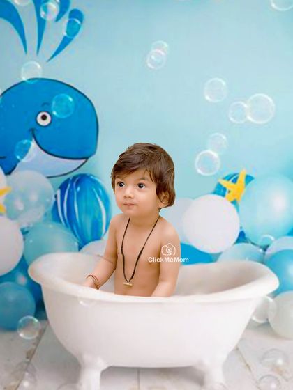 An under-the-sea adventure in our studio tub. The whale backdrop and floating bubbles add a touch of playful imagination to this splash session.