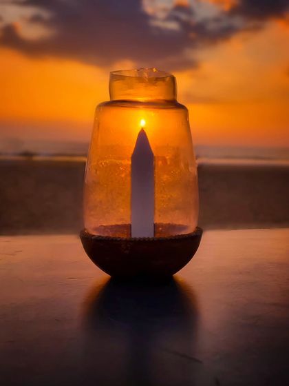 Another one of my creative sunset experiments. By placing a candle in a glass jar, I aligned it with the setting sun to make it seem as if the sun is the candle's flame.