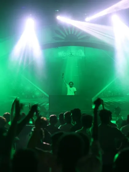 On stage at a Wonderla mini-concert, commanding a massive festival crowd. The professional lighting, the huge stage, and the sea of people create an electric atmosphere that I thrive on. I am experienced in handling main stage festival slots.