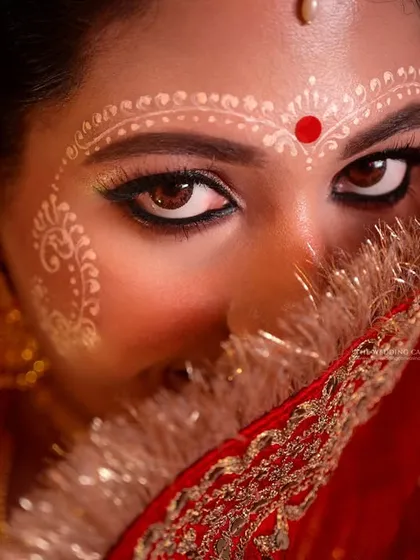 This is the essence of Bengali bridal beauty. I focus on capturing the soul through the eyes, highlighting the intricate 'Chandan' art that tells a story of tradition and grace. This kind of intimate, powerful portrait is a cornerstone of my work.