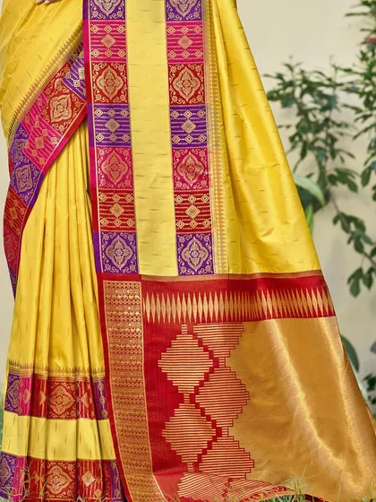 A vibrant yellow Dupion silk saree with a contrasting red border. This traditional saree is perfect for bringing a ray of sunshine to any celebration.