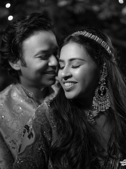 A classic black and white portrait capturing the bride's serene smile and the groom's loving gaze.