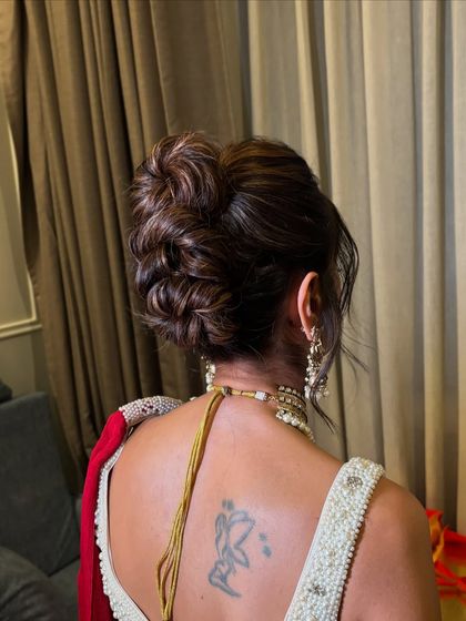 A side view of the high messy bun, showing the soft pieces around the face.