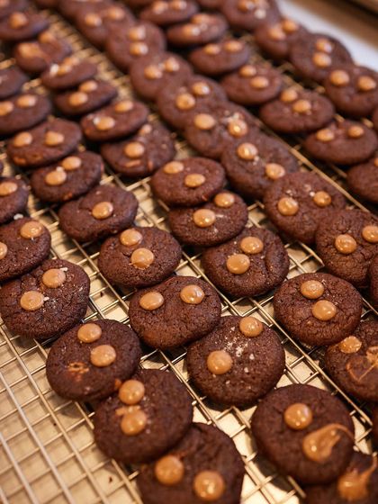 Fresh out of the oven. A tray of our gooey, chocolatey cookies, promising perfection in every single bite.