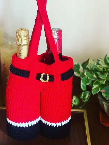Make your holiday gifting extra special with this unique Santa pants wine bottle cover. It’s a fun and festive way to present a bottle of wine or to simply add a touch of Christmas cheer to your home decor.