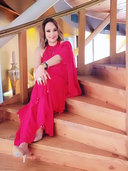 A candid moment on the stairs during the photoshoot. The makeup looks stunning even in a more relaxed setting.