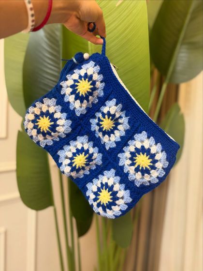 Another shot of the blue granny square pouch, perfect for keeping your essentials organized.
