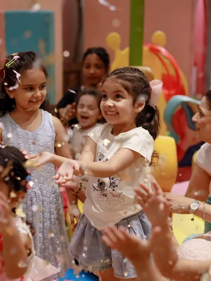 A confetti shower brings smiles to the faces of all the children at this barnyard party. It's a moment of pure, celebratory joy.
