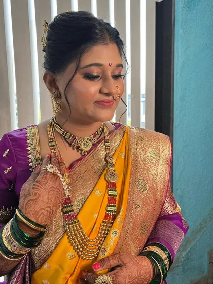 A candid moment showing the bride's complete look, from the intricate jewellery to the perfectly draped saree.