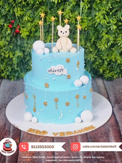 A starry two-tier teddy bear cake for Vedansh's birthday. The gentle blue colour and golden stars create a peaceful, dreamy look.