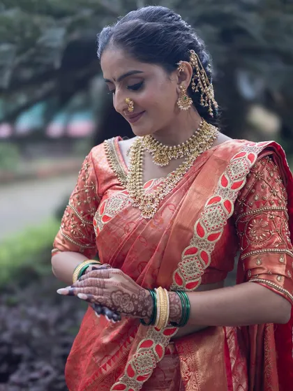 Another angle of the beautiful red and gold Nauvari, showing the rich texture of the fabric.