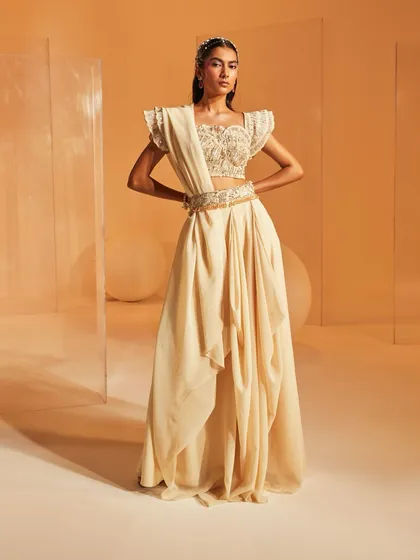 A full-length view of the Jenna Saree Set, showcasing the unique draped skirt and the powerful silhouette created by the structured, embellished blouse.