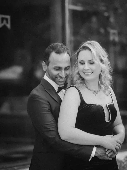 An elegant and serene black and white portrait. This pre-wedding photo has a quiet, romantic feel, focusing on the couple's gentle embrace.