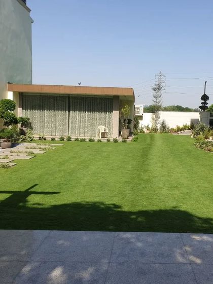 A sprawling, perfectly maintained lawn at a mini-farm, demonstrating my capability for handling large-scale residential projects.