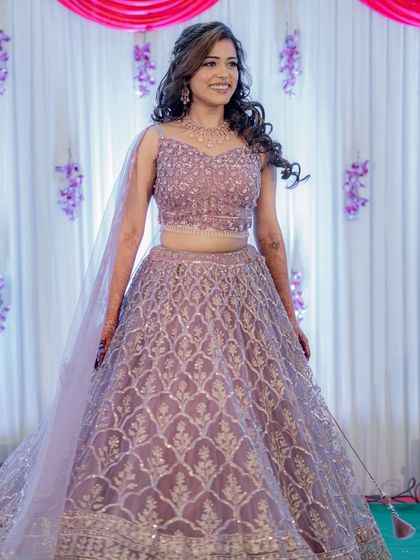 A full view of Manali's beautiful lilac sangeet lehenga. The soft, glowing makeup ensures she looks radiant and ready to dance the night away.