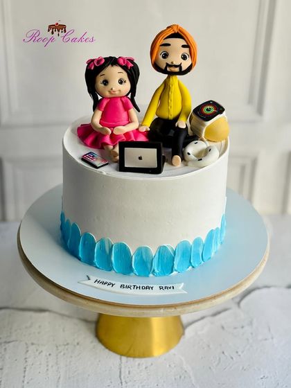 A heartwarming cake for a dad's birthday from his daughter. The topper features custom fondant figures of the father and daughter, surrounded by their favorite gadgets like an iPad and Apple Watch.