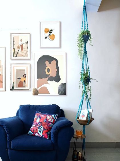 Here's my 9-foot plant hanger styled in a living room. The pop of turquoise adds so much life to the space, and the bottom tier is perfect for holding books or other small items.