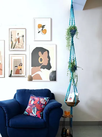 Here's my 9-foot plant hanger styled in a living room. The pop of turquoise adds so much life to the space, and the bottom tier is perfect for holding books or other small items.