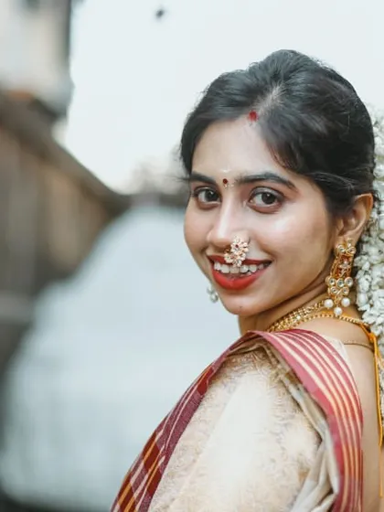 A close-up of a beautiful bride from a Kerala Kalyanam. I draped her traditional Kerala saree to complement her gajra hairstyle and temple jewelry, creating a timeless and authentic South Indian bridal look.