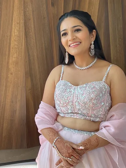A close-up of the client's happy smile and radiant makeup.