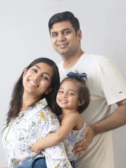 A happy and bright family portrait. The clean background ensures that the family's loving connection is the star of the show.