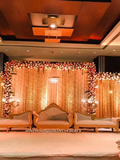 A wide shot of the Sahara Star Hotel ballroom stage, showcasing the complete seating arrangement for the couple and their family. The design ensures the couple remains the center of attention throughout the event.