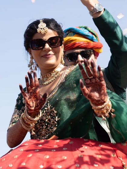 This couple knows how to have fun. The bride and groom are rocking sunglasses and looking super cool during their carnival entry.