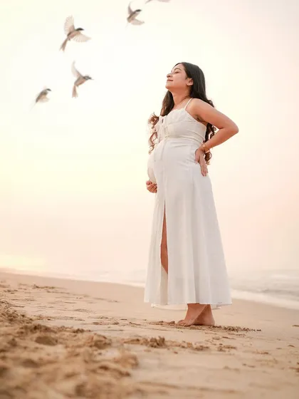 There is a serene beauty in motherhood. We captured this quiet moment of reflection for a mama-to-be during a golden hour beach session.