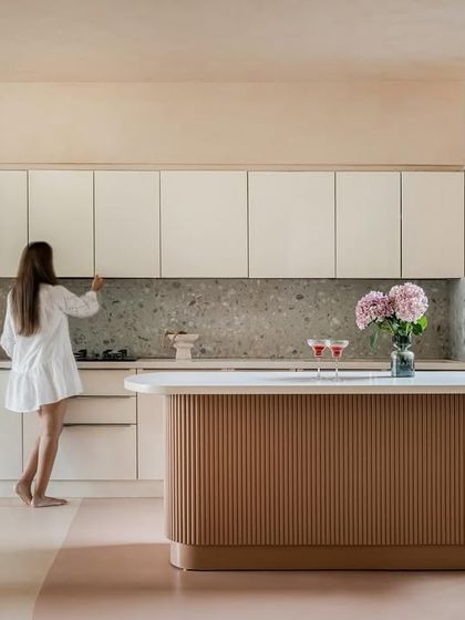 The open kitchen in the "House of Mousse" is both functional and beautiful. The island provides a casual dining spot, while the clean lines and neutral palette keep the space feeling uncluttered and connected to the living area.