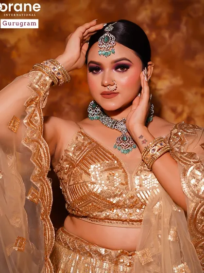 This student portfolio piece showcases a golden glam look with a smokey eye. It's a classic party look that is always in demand.