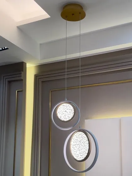 This mesmerizing chandelier features a unique water bubble effect within its circular pendants. It adds a touch of enchanting elegance and visual interest to this beautifully designed bedroom.