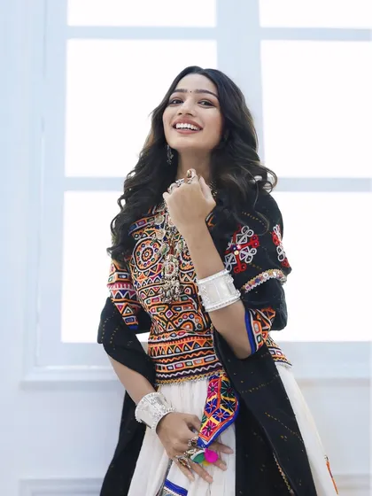 A look that shines brighter than the moonlight. For Navratri, we styled her in this gorgeous white chaniya choli with natural makeup and soft waves, making her the queen of the Garba night.
